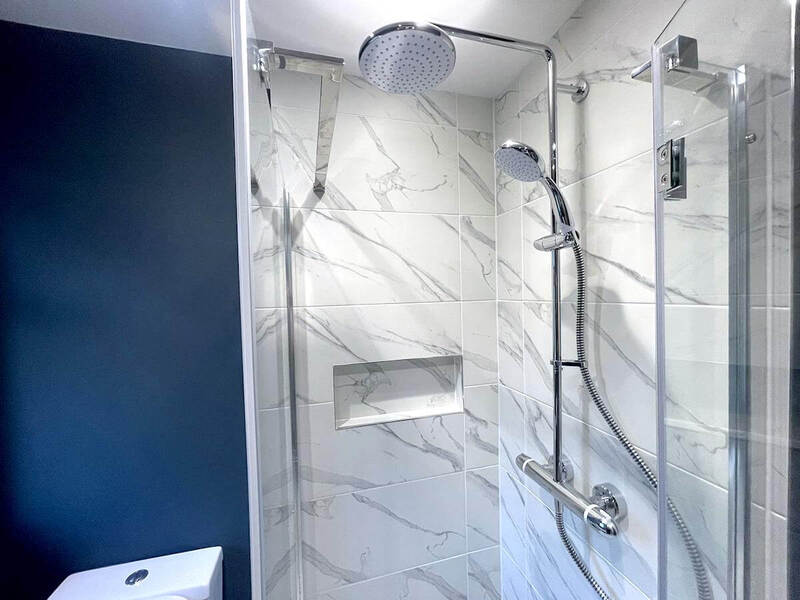 Glass shower enclosure complimenting a sophisticated and functional space.