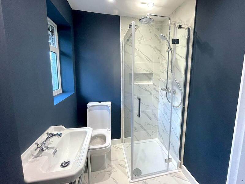 Creating a serene and elegant bathroom in St Albans with blue wall painted design.