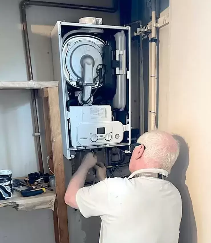 Gas engineer completing a boiler service in Watford