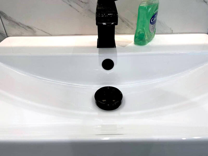 Close-up photo of a vanity basin in a renovated bathroom in St Albans, focusing on the elegant black tap highlighting the attention to detail and contemporary design choices